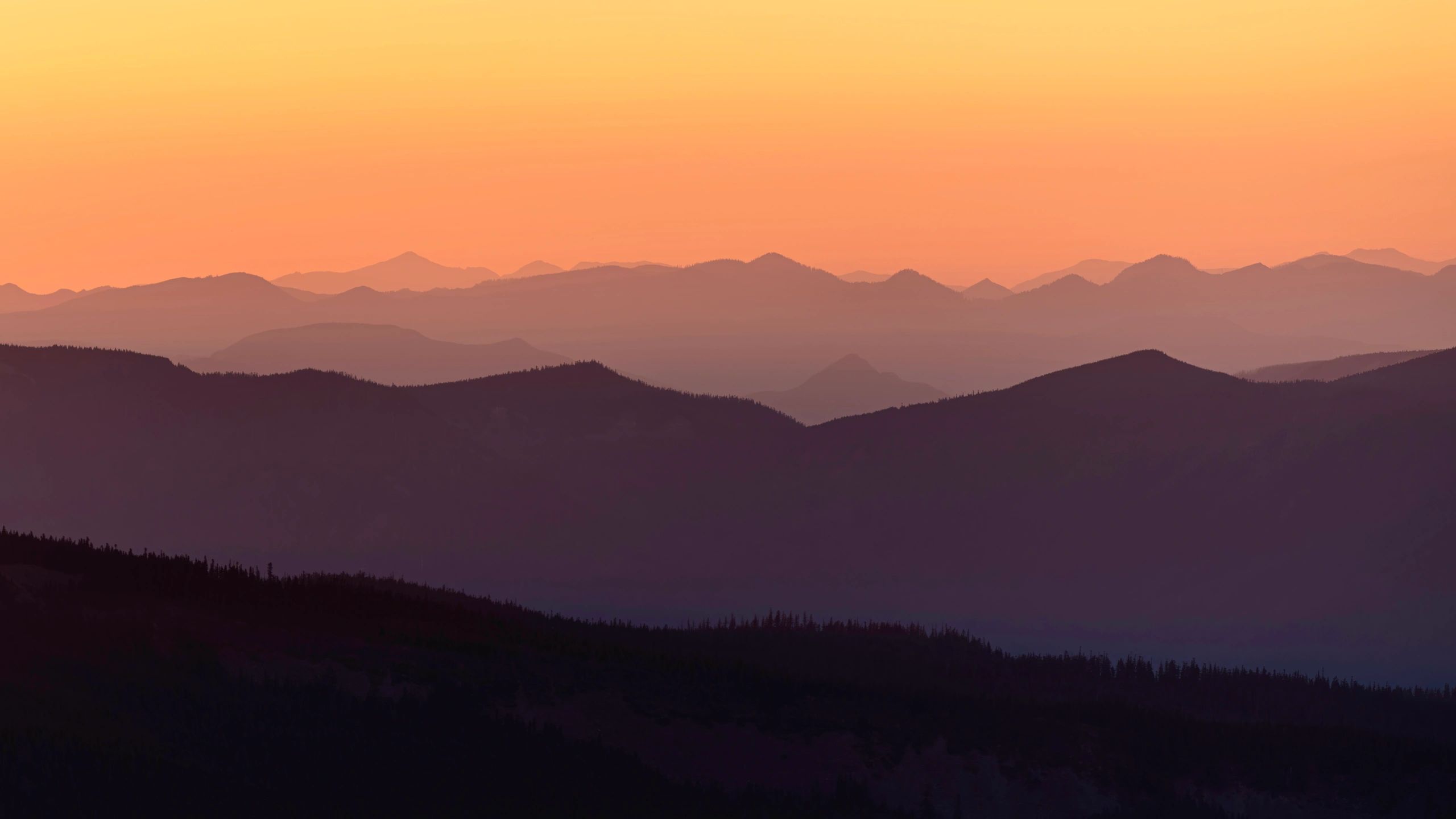 Layered mountain ranges at sunset